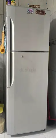 Well-maintained double-door refrigerator (top freezer) — good working condition.