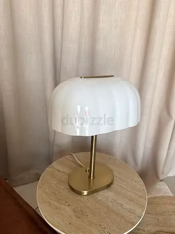 Modern white glass bedside table lamp with brass base