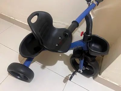 Used toddler tricycle with parent handle and storage trays