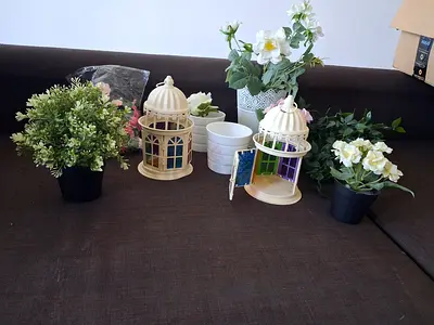 Assorted artificial plants and decorative birdcage tealight holders