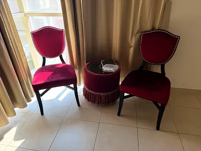 Pair of vintage red velvet dining chairs with decorative studs