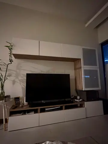 Modern wall-mounted entertainment center with storage cabinets and TV unit