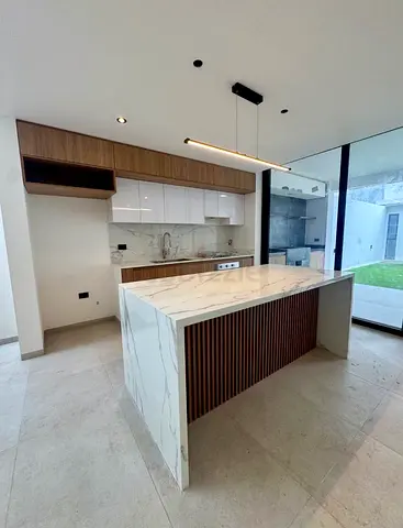 Custom Kitchen Counter Installation with Marble Slab and Matching Wall Finish