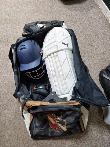 Used cricket kit: batting pads, helmet and accessories in carry bag