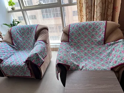 Pair of three seater and single-seater armchairs with protective covers - good condition