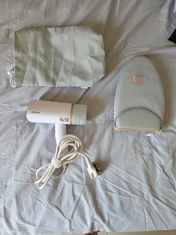Handheld Philips Garment Steamer with Heat-Resistant Pad
