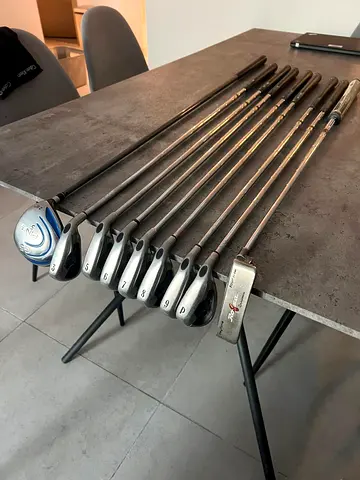 Complete set of used golf clubs with putter and woods