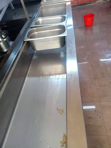 Used stainless steel commercial kitchen prep table with sinks - good condition