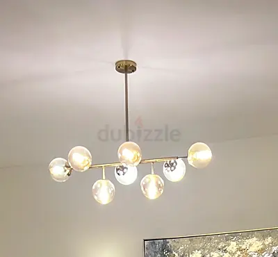 2 Modern brass chandeliers one with 12 glass lights, and 8 globes suitable for dining table.