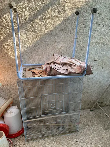 Metal bird cage on stand with wheels — used, good condition