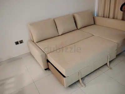 Beige L-shaped sofa bed with storage, good condition