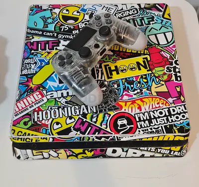 Stickered PS4 Slim, controller, charging deck, 7 CD games, headphones
