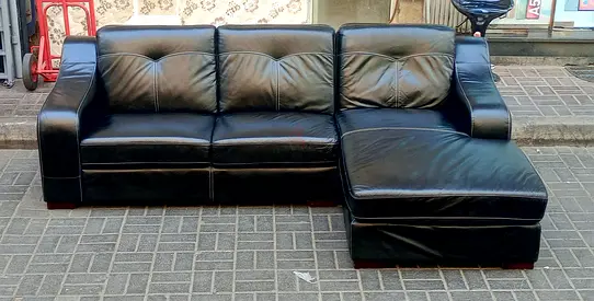 Black leather L‑shaped sofa with chaise (good condition)