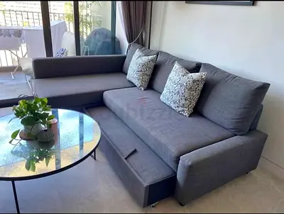 Grey L-shaped Sofa with Pull-out Bed - Good Condition