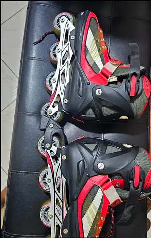 Red and black adjustable inline rollerblades, used, size approx. EU 39-42