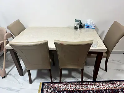 Beige faux-leather dining chair with wooden legs