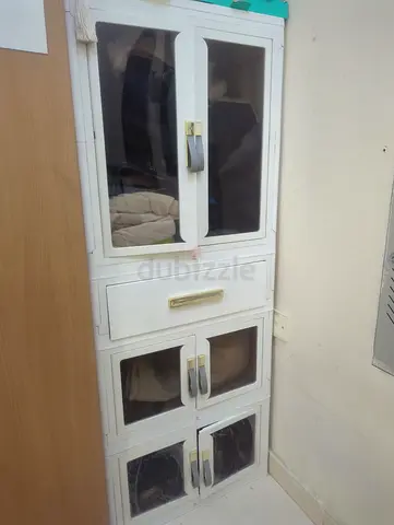 White tall storage cabinet with glass doors - good condition