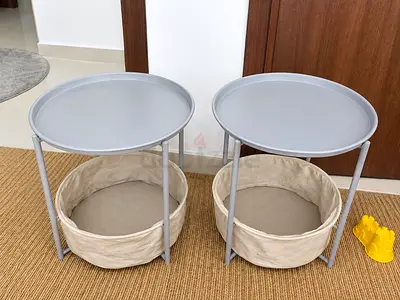 Pair of small round side tables with removable fabric baskets - light grey