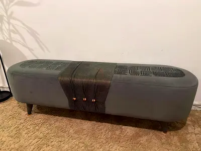 Long upholstered storage bench with decorative leather strap
