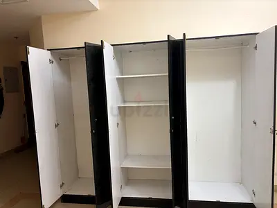 Large 4-door white wardrobe with shelves and hanging space