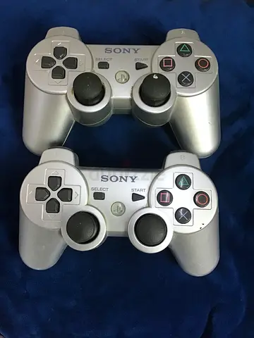 Pair of silver Sony DualShock 3 controllers (used)