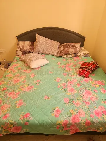 King size bed frame with mattress and floral bedding - used
