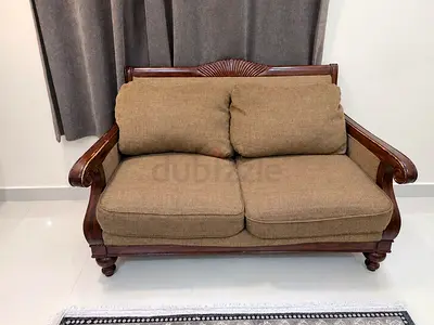 Two-seater wooden frame sofa with brown cushions - good condition