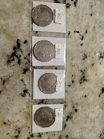 Set of four UK 50p commemorative coins (2011-2022) in holders