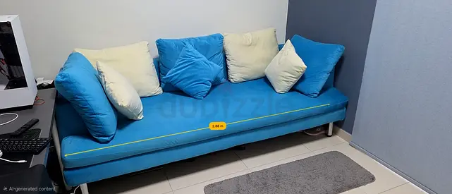 Blue upholstered sofa bed / lounge with cushions - good condition