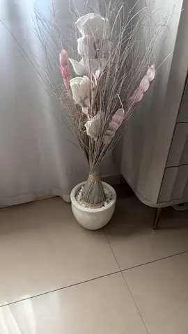 Decorative dried floral arrangement in white ceramic pot