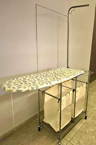 Ironing board with built-in laundry sorter and hanger -