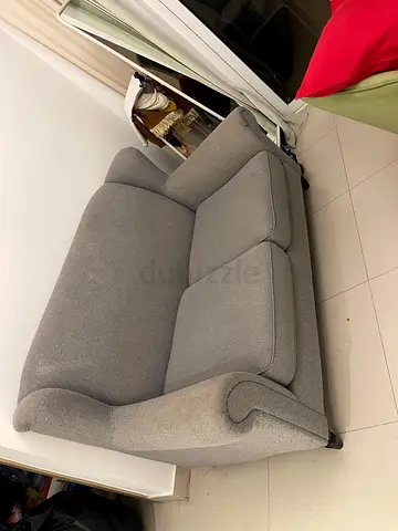 Two-seater grey fabric sofa in good condition