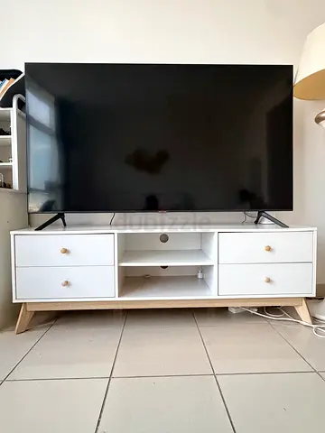 White wooden TV cabinet with drawers and open shelving