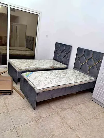 Pair of single beds with headboards and mattresses - grey velvet