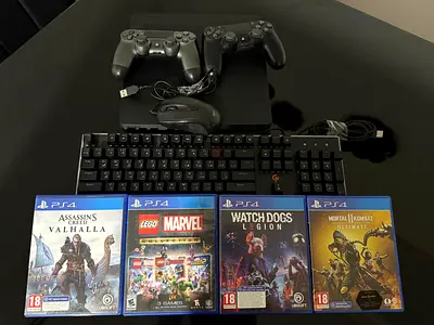 PlayStation 4 Slim with two controllers, four CDs, a mouse, and a keyboard.
