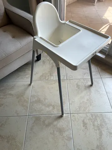 Simple white baby high chair with tray - sturdy and clean