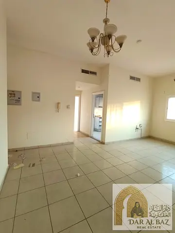 One-bedroom apartment with a living room in Al Majaz 2, featuring an open view. Includes free central air conditioning (covered by the landlord) and a