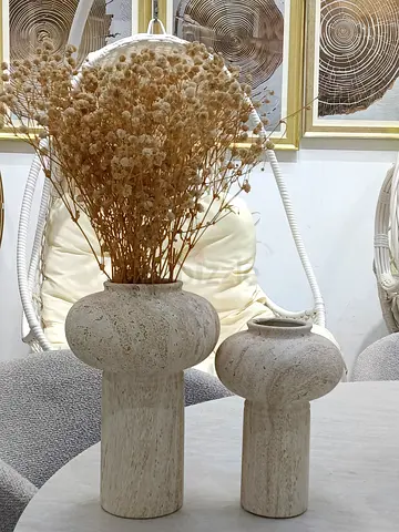Pair of neutral stone-look decorative vases with dried flowers