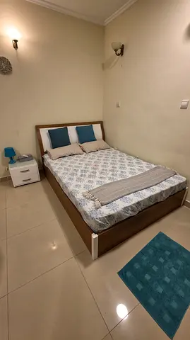 Queen wooden bed frame with mattress and bedside table - good condition