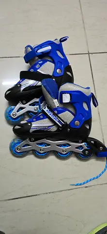 Pair of adjustable blue inline roller skates - size adjustable, good condition