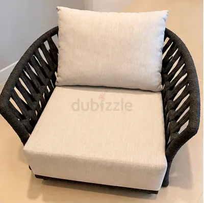 2 Outdoor woven lounge chairs - grey frame, beige cushions with covers.
