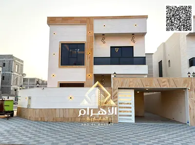 5-bedroom villa for sale in the Al Helio area, Ajman. The villa features a kitchen equipped with essential appliances and offers direct access.