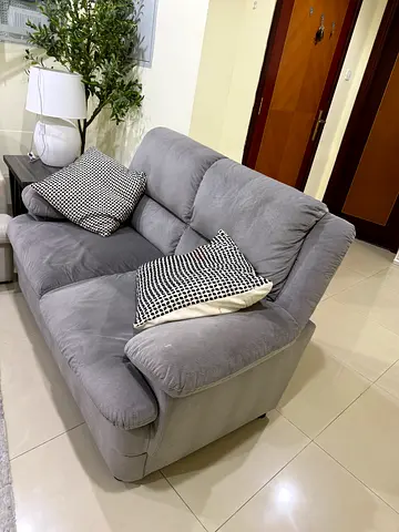 Comfortable 2-seater grey fabric sofa in good condition