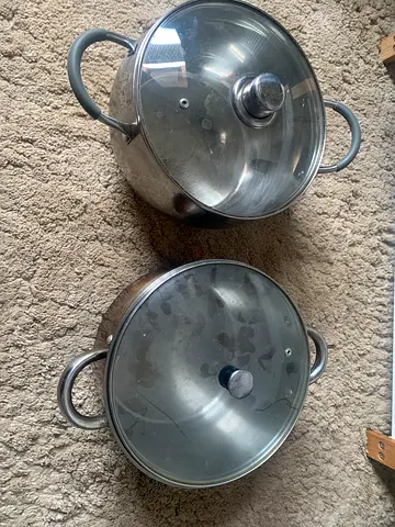 Set of 2 stainless steel cooking pots with lids - used