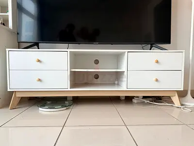 White wooden TV cabinet with drawers and open shelving