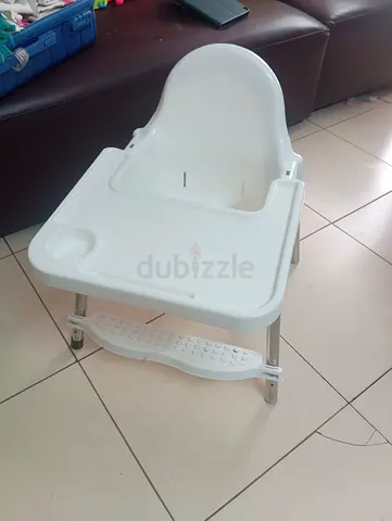 White plastic baby high chair with tray and footrest. Free take away. First came can take