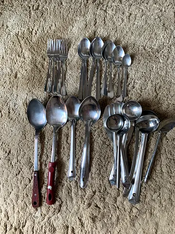 Mixed stainless steel kitchen cutlery and serving spoons set (used)