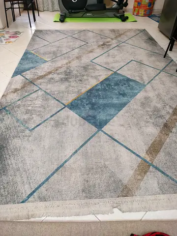 Light gray geometric area rug with blue accents - gently used