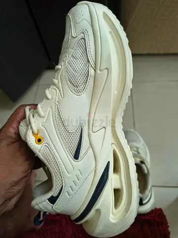 Used white athletic sneakers, size not marked — casual running style
