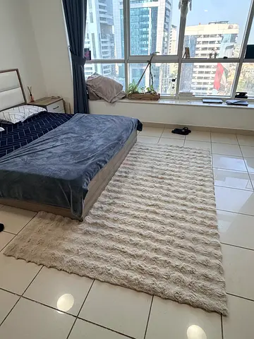 Beige textured $%&! rug - good condition, 2.5m x 1.6m (approx.)
